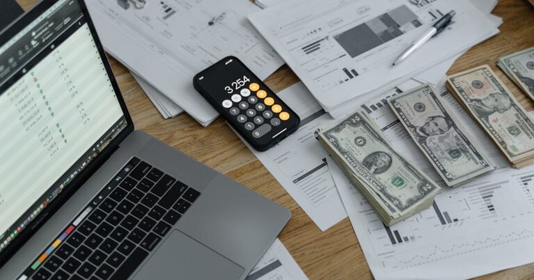 Student working on accounting with a calculator and ledger